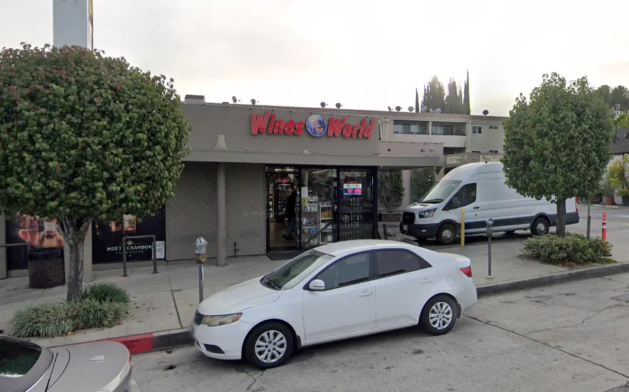 Wines of the World liquor store in Sherman Oaks, with a white car parked in front.