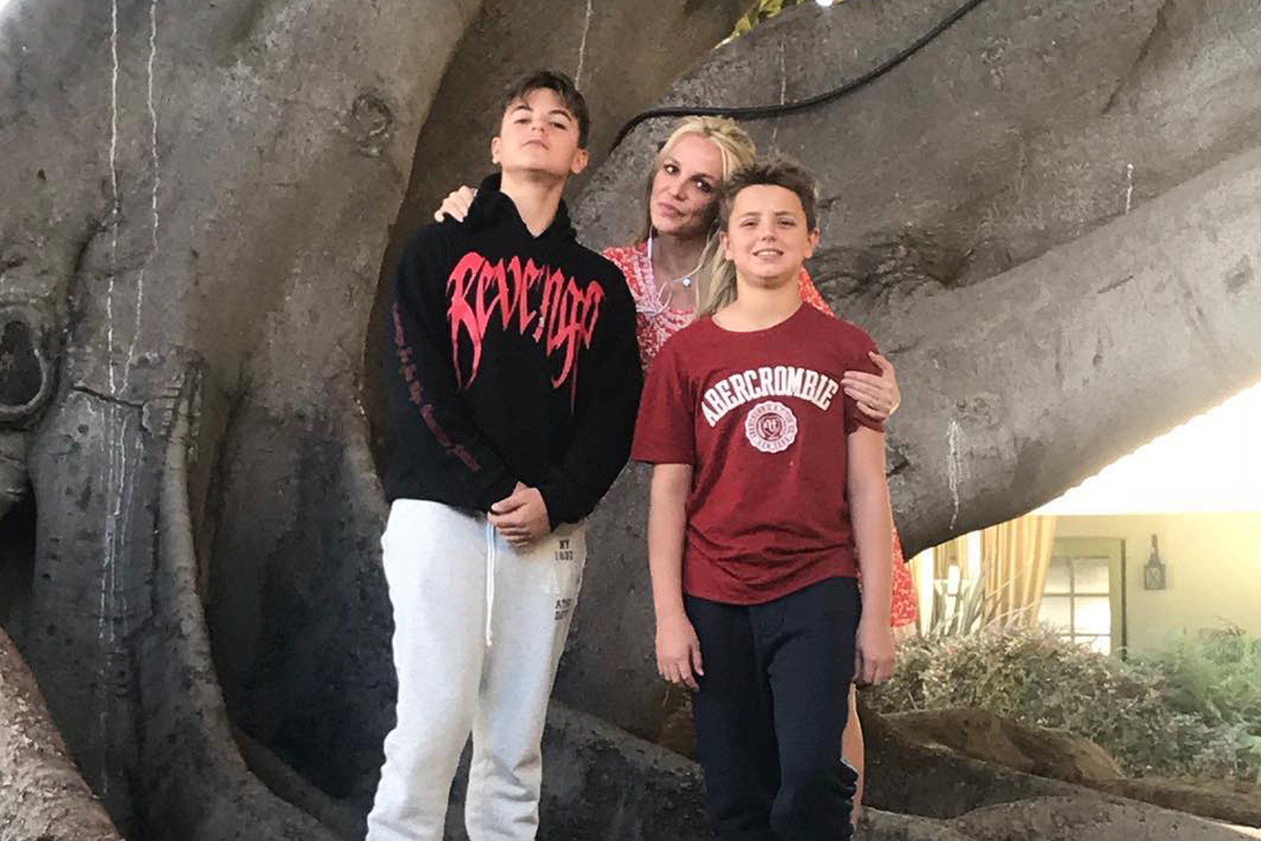 Britney Spears standing with her two sons.