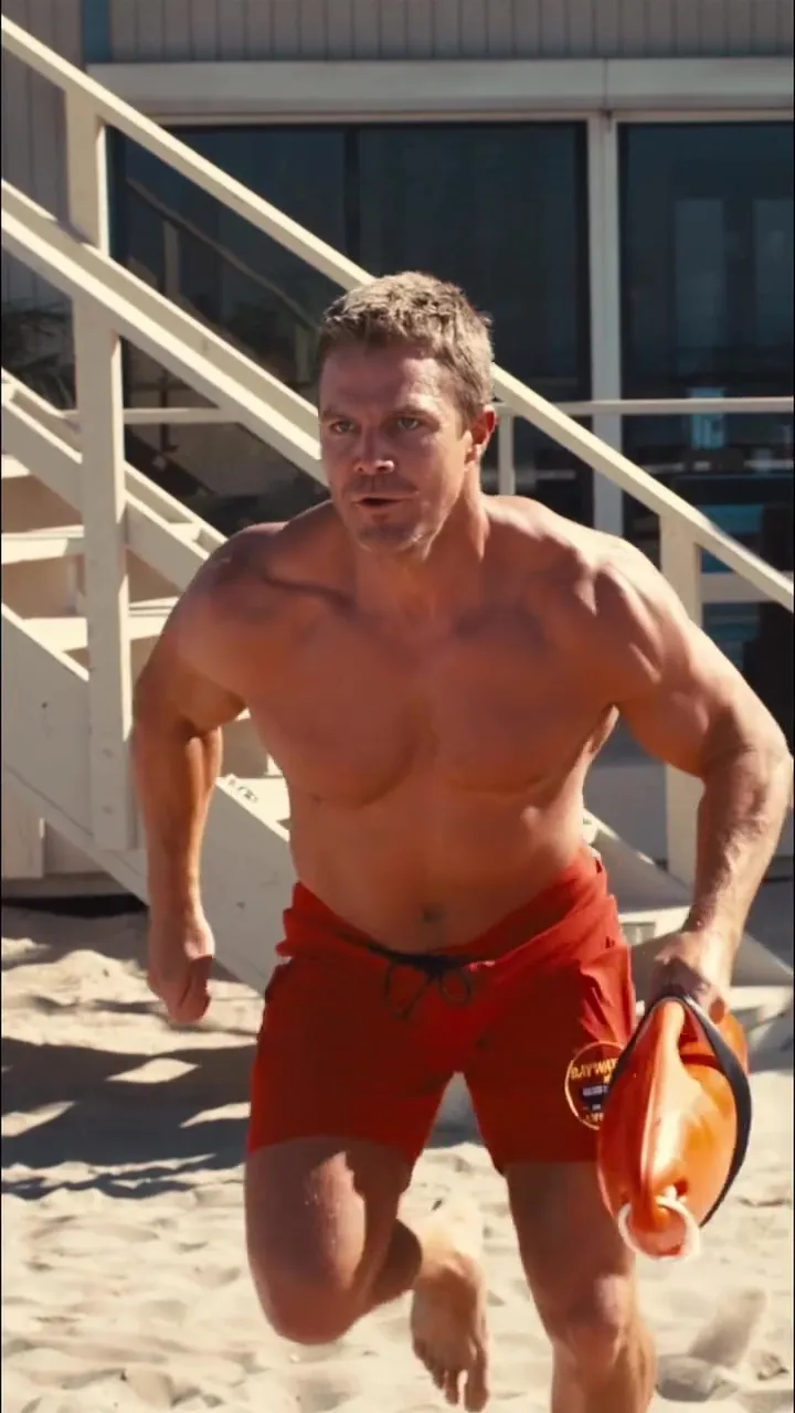 Livvy Dunne in a red Baywatch swimsuit.