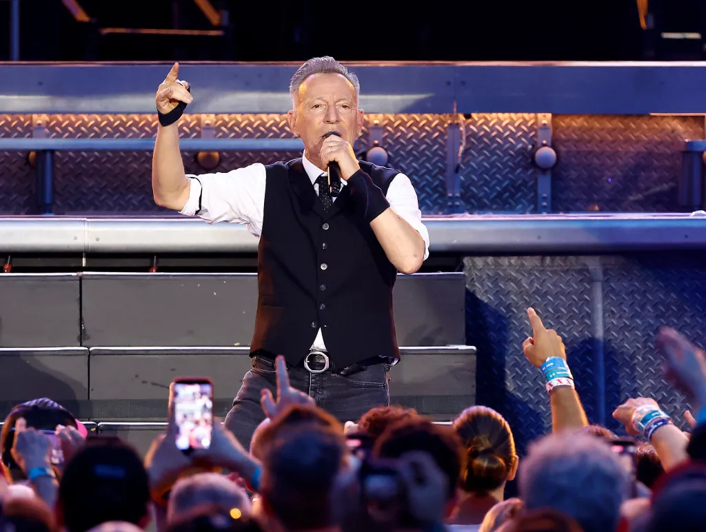 Bruce Springsteen performing live on stage.