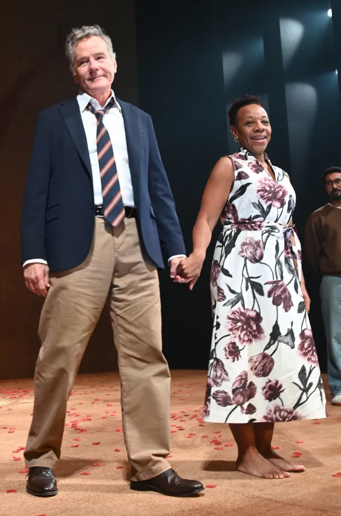 Bryan Cranston and Marianne Jean-Baptiste holding hands and bowing on stage.