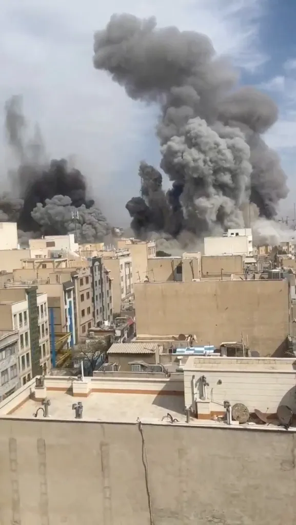 Smoke rises from reported explosions in Tehran, Iran.