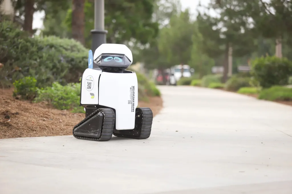 A Daxbot robot on a sidewalk, performing a citywide ADA sidewalk assessment.