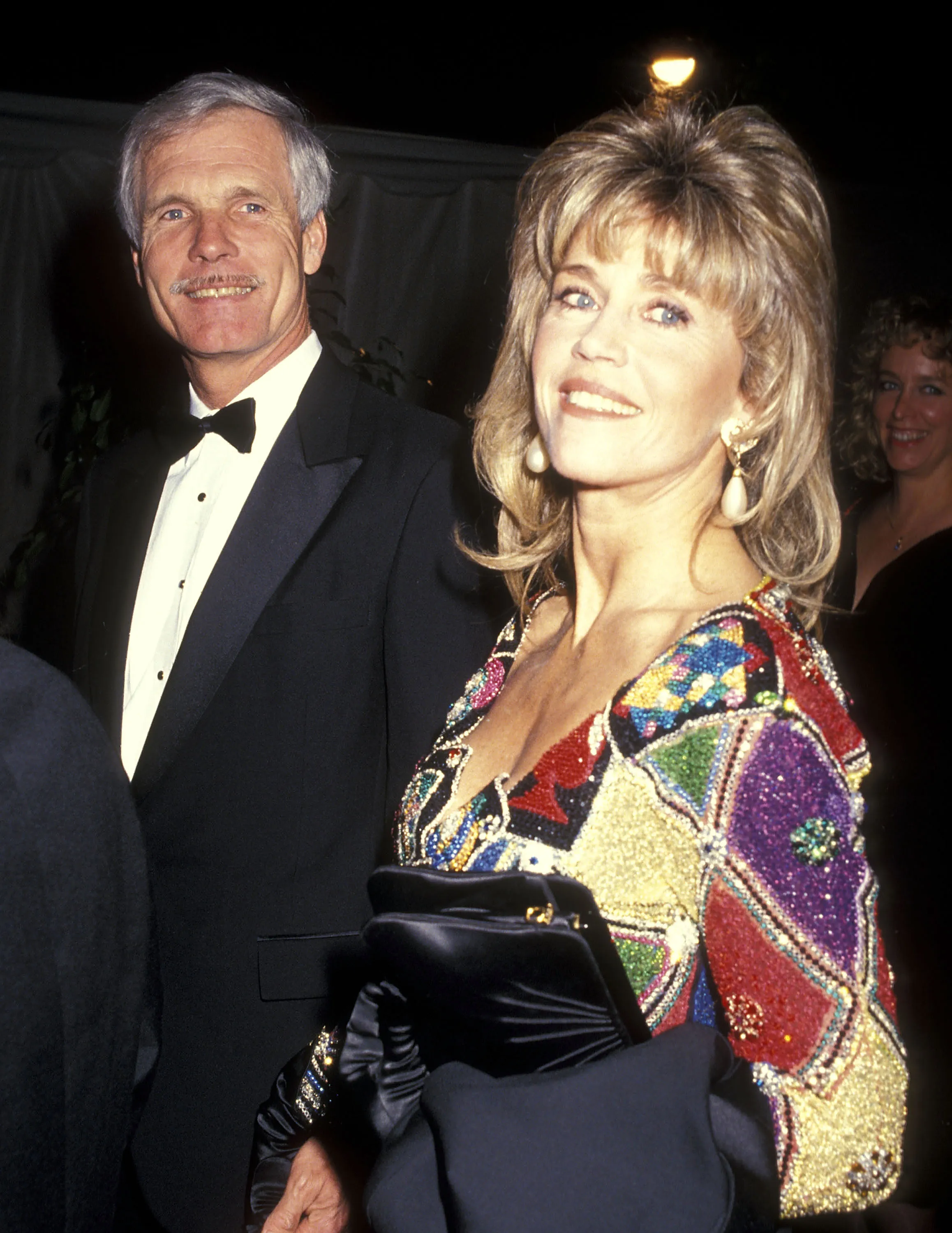 Ted Turner in a tuxedo and Jane Fonda in a colorful sequined dress.
