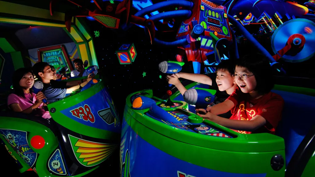 Guests riding the Buzz Lightyear Astro Blasters attraction at Disneyland Park.