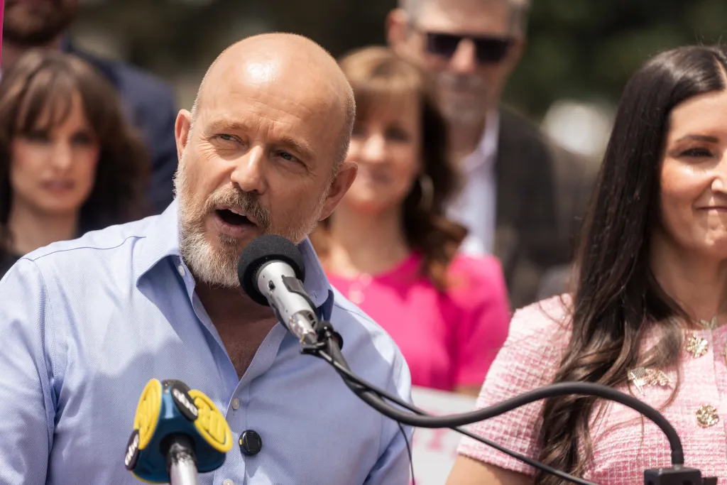 California gubernatorial candidate Steve Hilton speaks into a microphone.