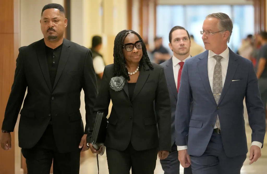 Carla Wyatt, Harris County treasurer, walking with attorney Christopher Downey.