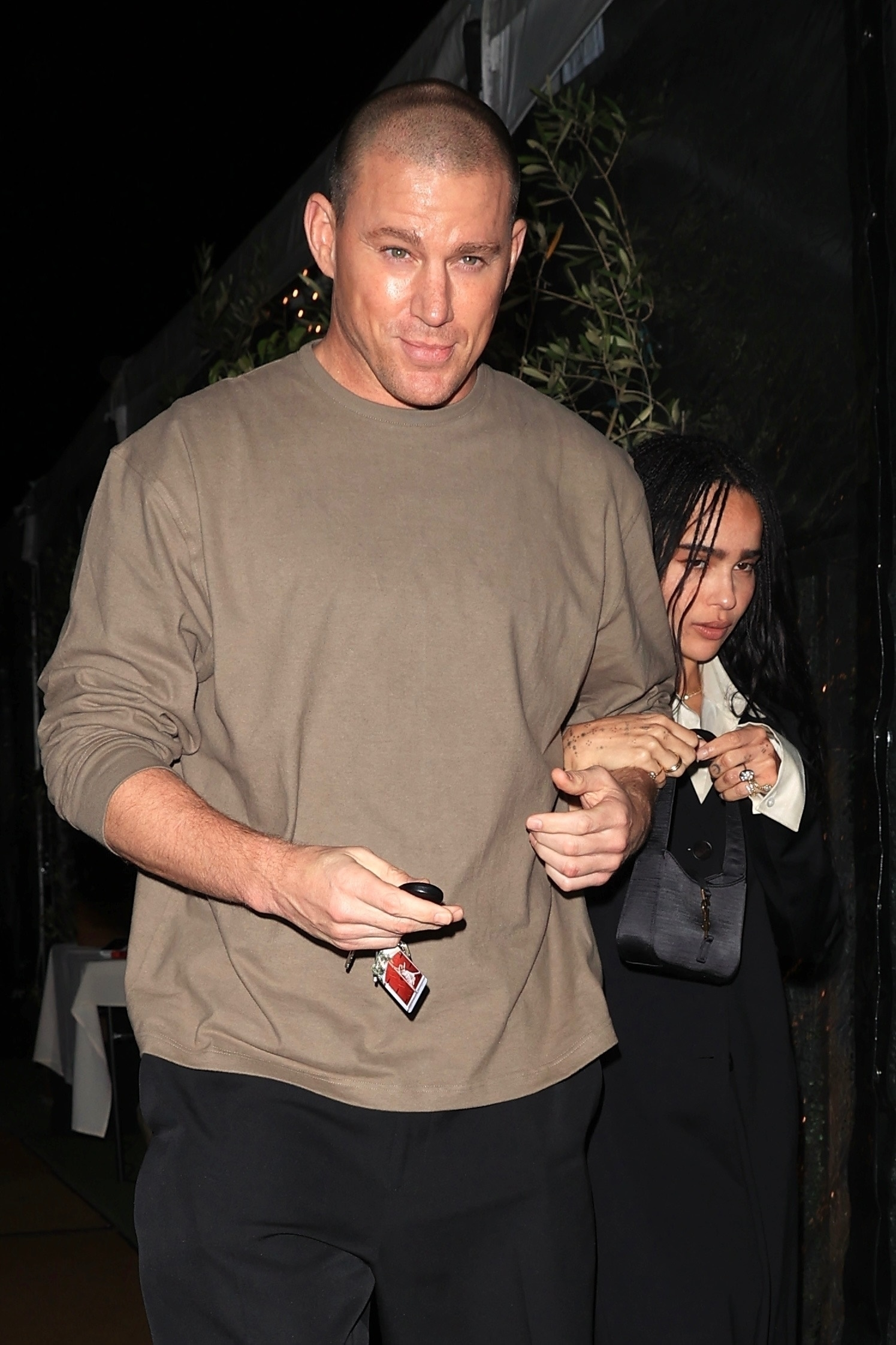 Channing Tatum and Zoë Kravitz holding hands while leaving dinner.