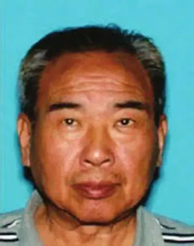 Headshot of Chen Jun against a light blue background.