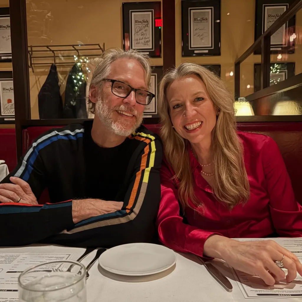 Cheryl Strayed and her husband, Brian Lindstrom, sitting together at a restaurant.