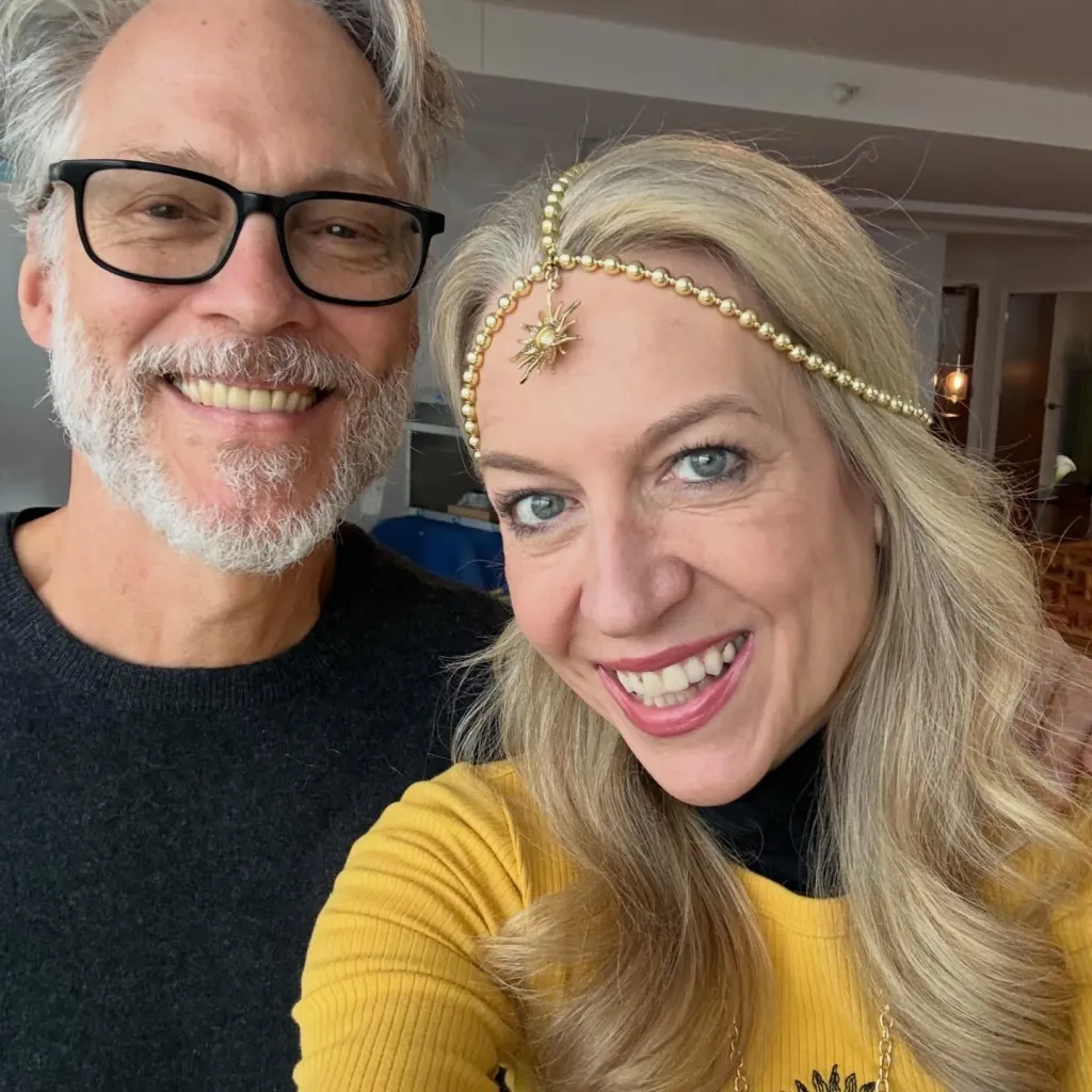 Cheryl Strayed and her husband, Brian Lindstrom, smiling at the camera.