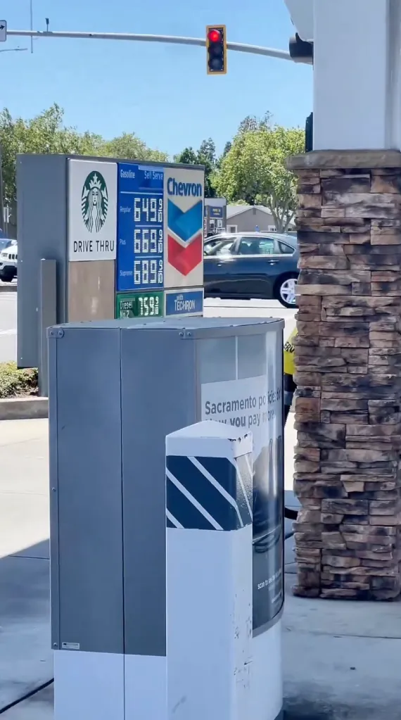 A Chevron gas station with a sign advertising gas prices of $6.49 for regular, $6.69 for plus, and $6.89 for supreme, along with a pump sign stating 