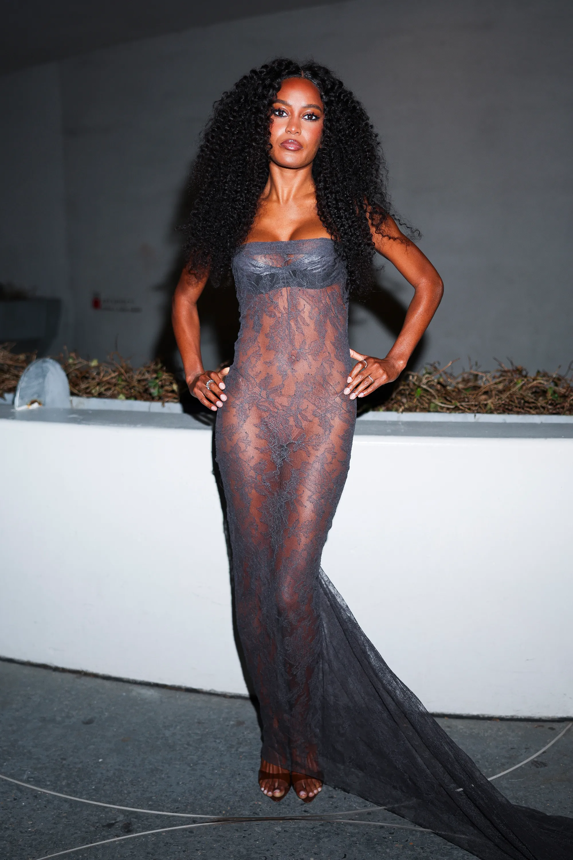 Ciara Miller in a sheer lace gown.