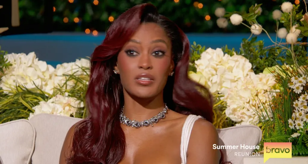 Ciara Miller with red hair and a sparkling necklace on the 