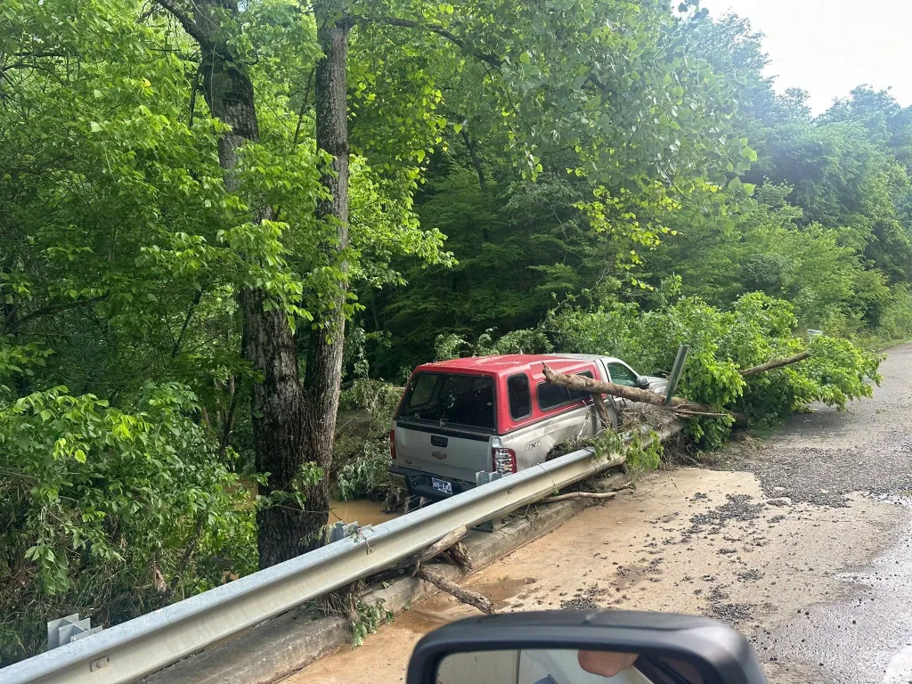 Flood waters carried a truck across a barricade on the side of the road in Cocke County, Tennessee.