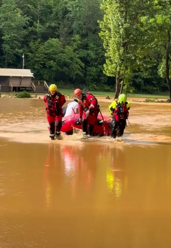 A resident is brought to safety by a crew of first responders during after a flash flooding in Tennessee.