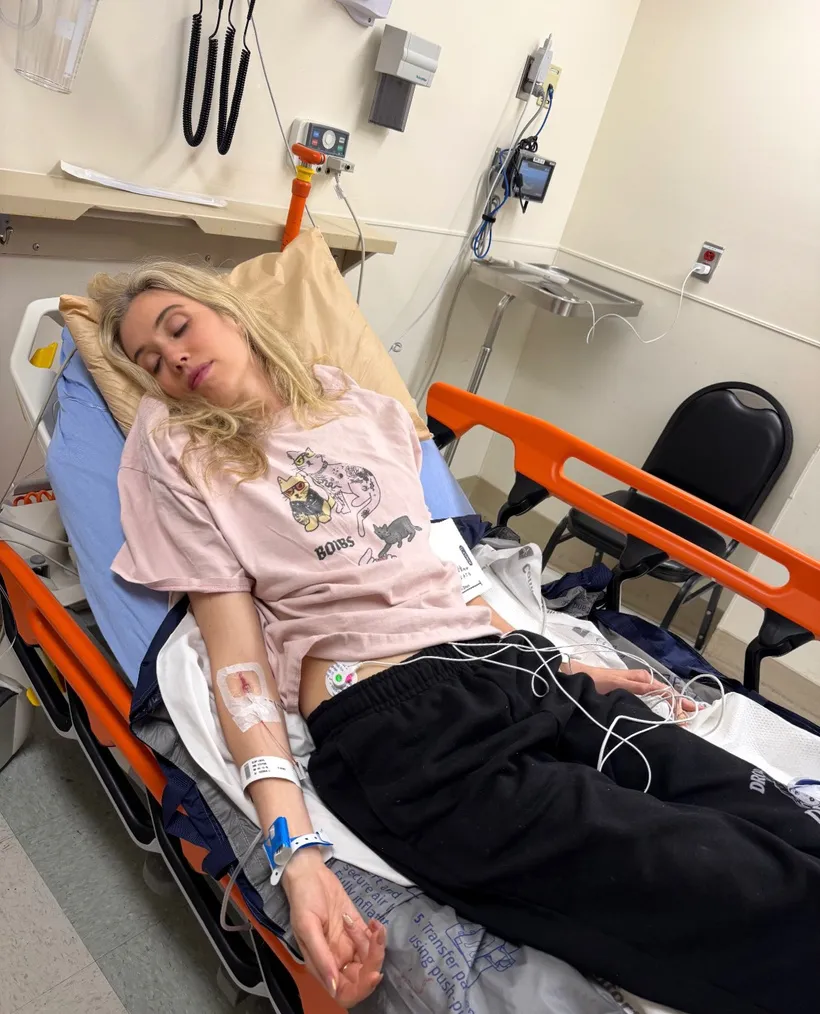 Comedian Laura Clery injured and lying on a hospital gurney.