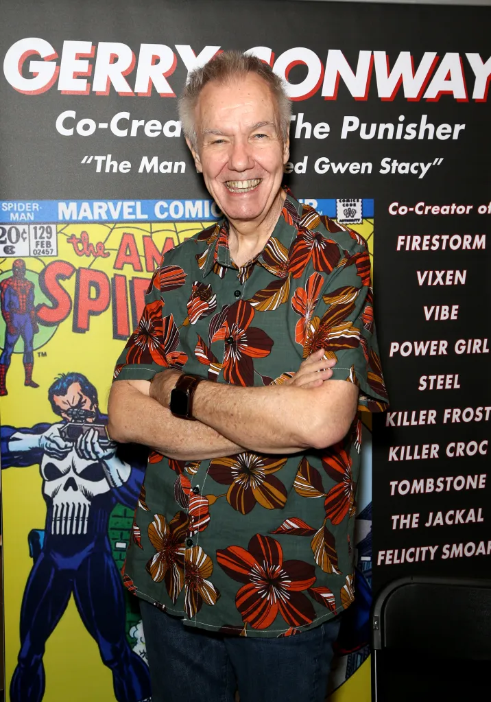 Comic book writer Gerry Conway smiling in front of a display detailing his creations, including The Punisher.