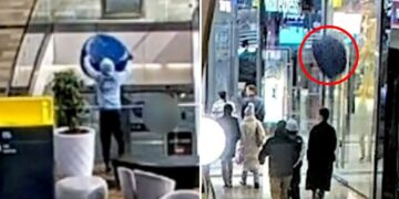 Shocking moment teen throws 30-pound chair from top floor shopping mall