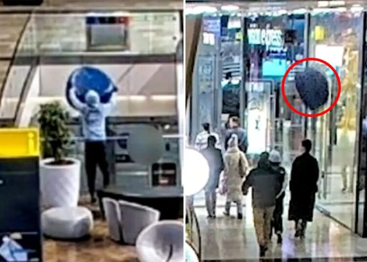 Shocking moment teen throws 30-pound chair from top floor shopping mall