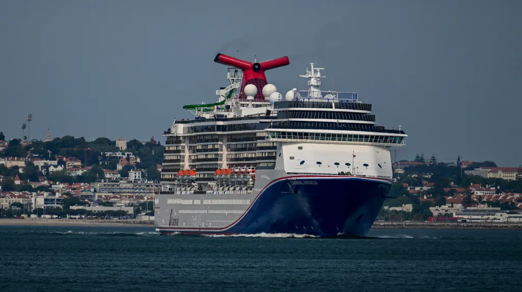 Carnival Miracle cruise ship sailing the Tagus River in Lisbon, Portugal.