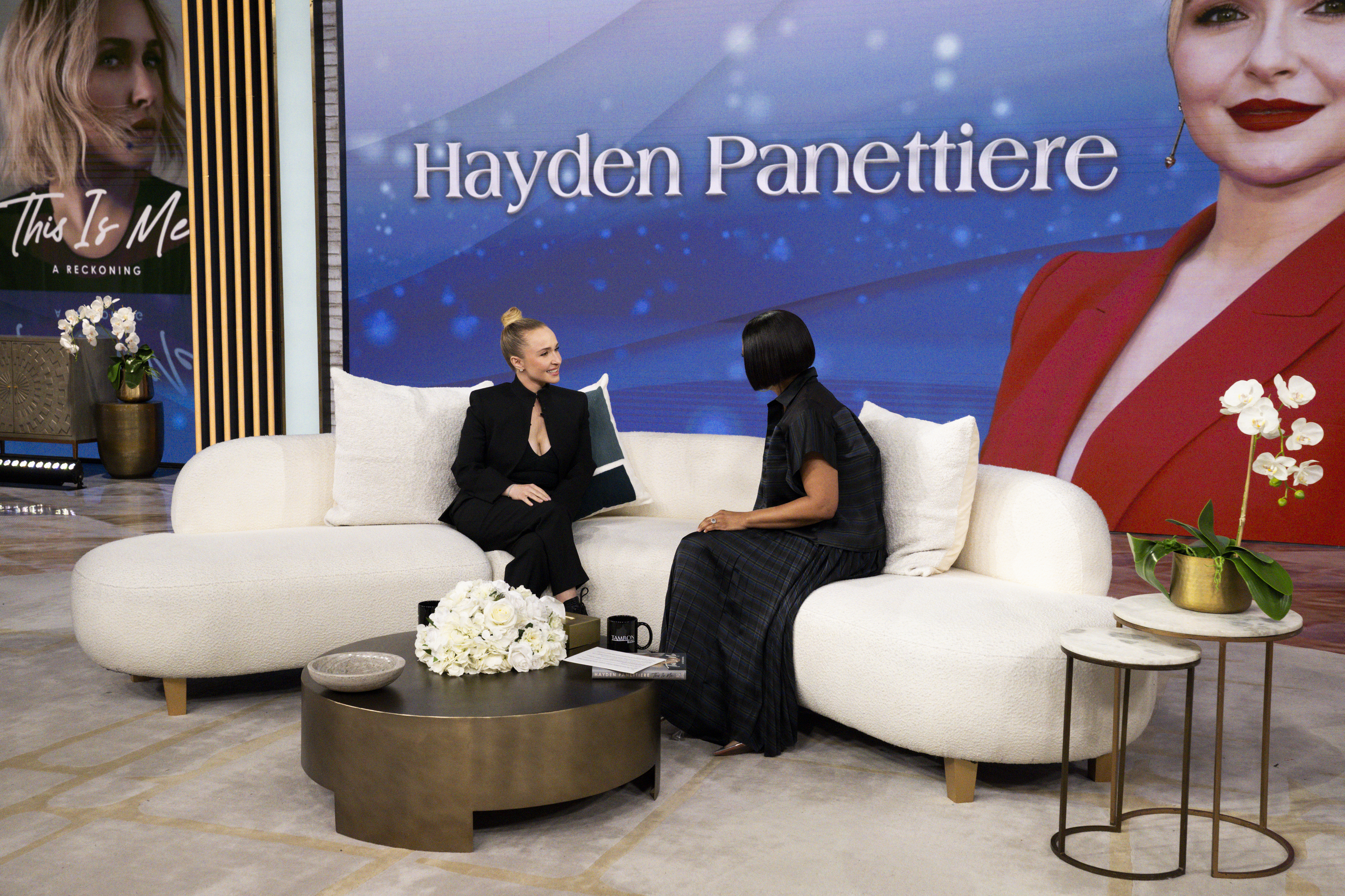 Hayden Panettiere and Tamron Hall sitting on a white sofa during an interview.