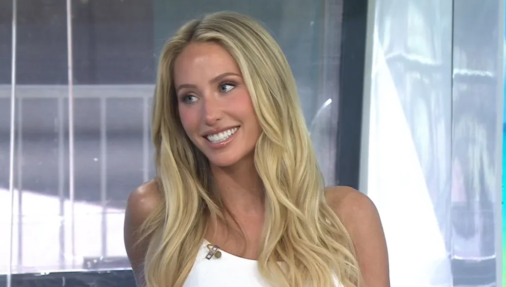 Alix Earle smiling at an interview.