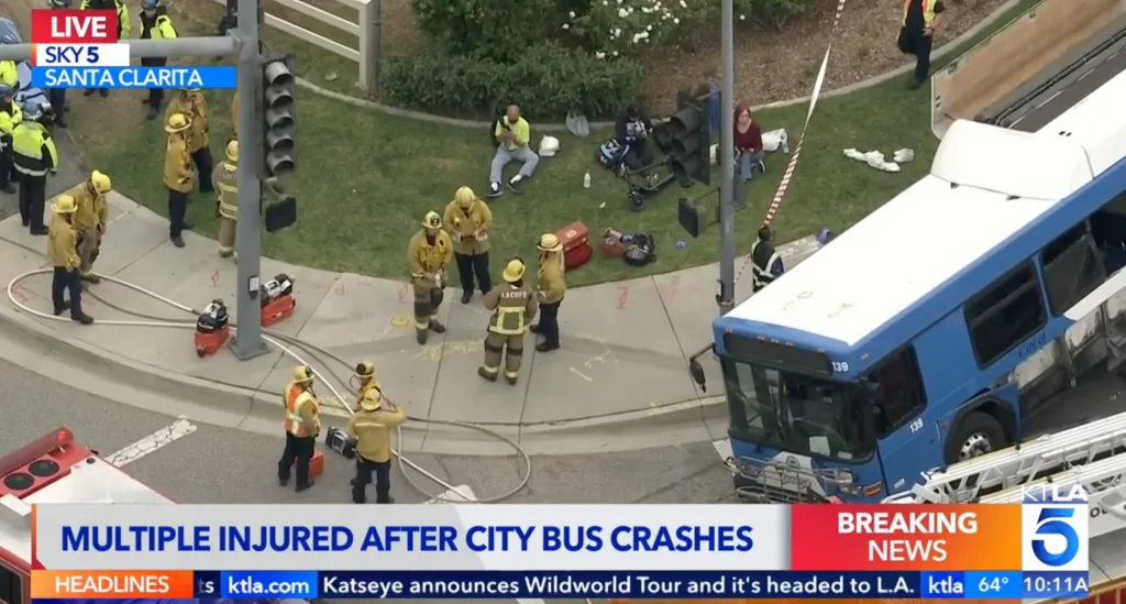 A crashed Santa Clarita Transit bus and emergency personnel at the scene of a multiple-injury accident.