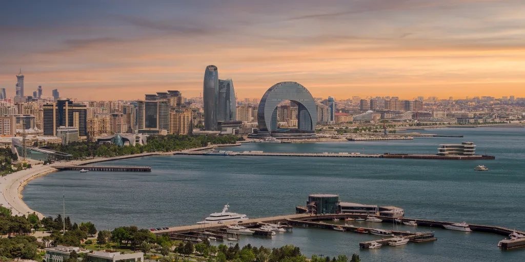 Crescent Development Project at sunset along the Caspian Sea coast in Baku, Azerbaijan, featuring distinct modern architecture.