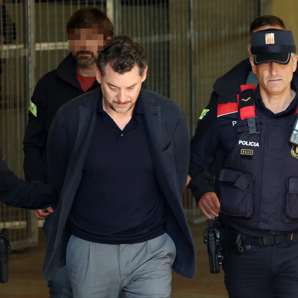 Catalan regional police officers (Mossos d'Esquadra) escort Jonathan Andic as he arrives at a court in Martorell, near Barcelona, following his arrest on May 19, 2026.