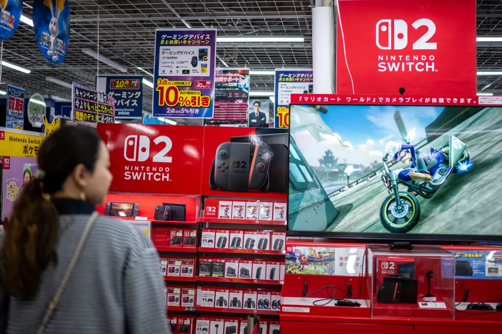 A customer browsing Nintendo Switch 2 products and accessories in a store in Japan.
