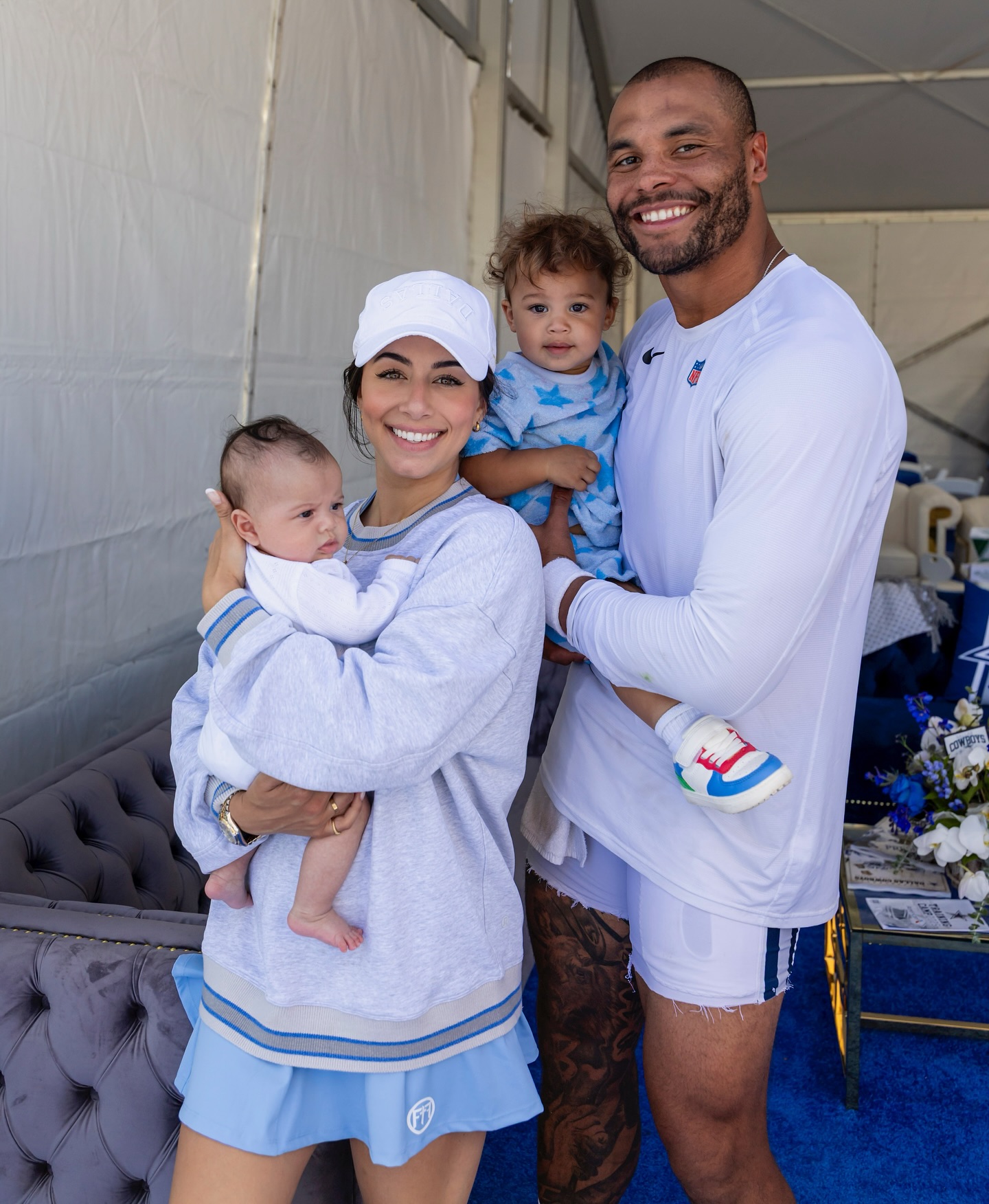 Dak Prescott and Sarah Jane Ramos holding two children.