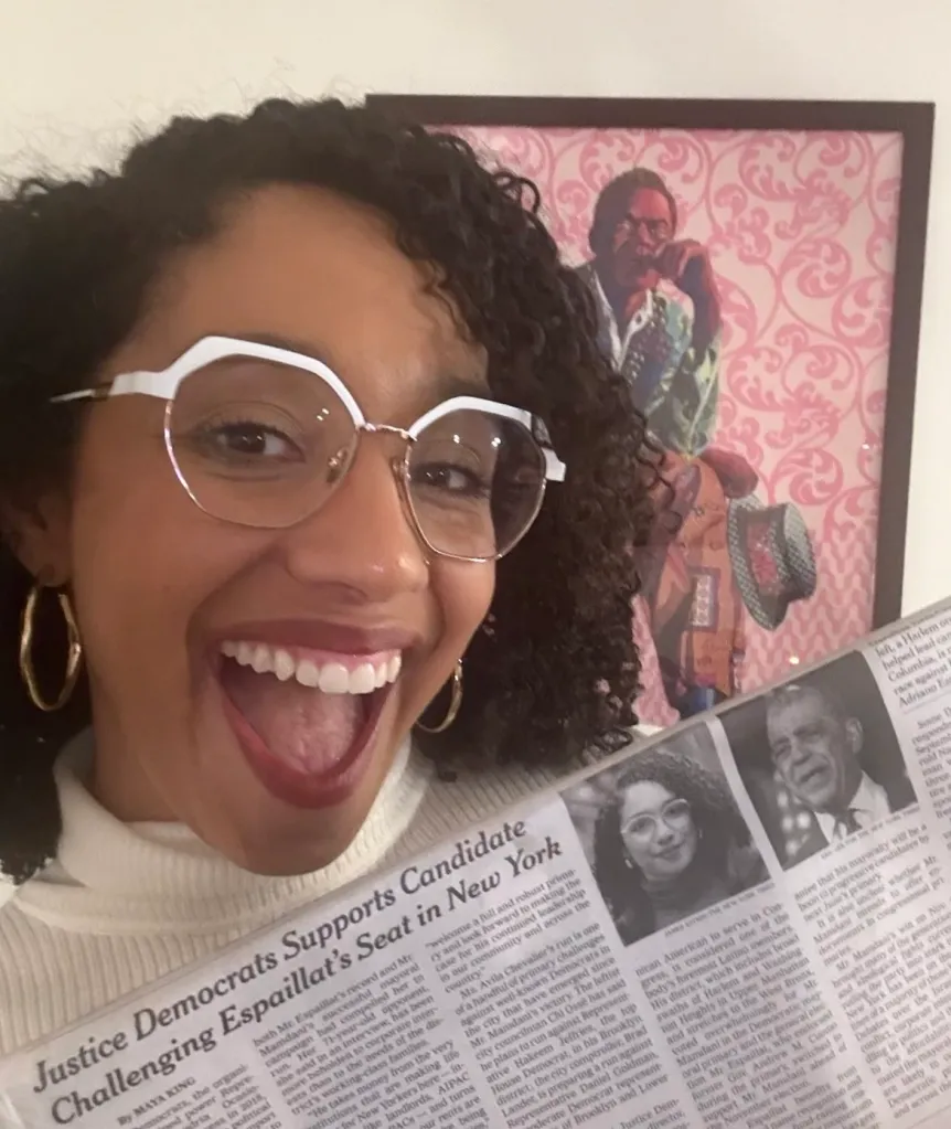 Darializa Avila Chevalier holds up a newspaper article celebrating her endorsement her primary race for Congress.
