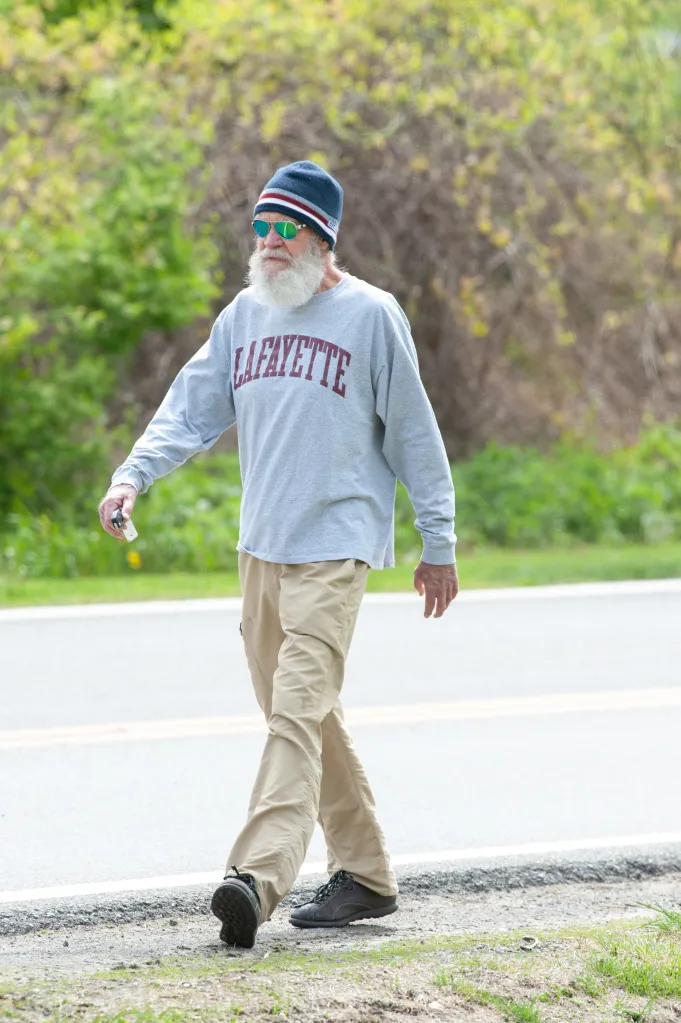 David Letterman walks along a highway.