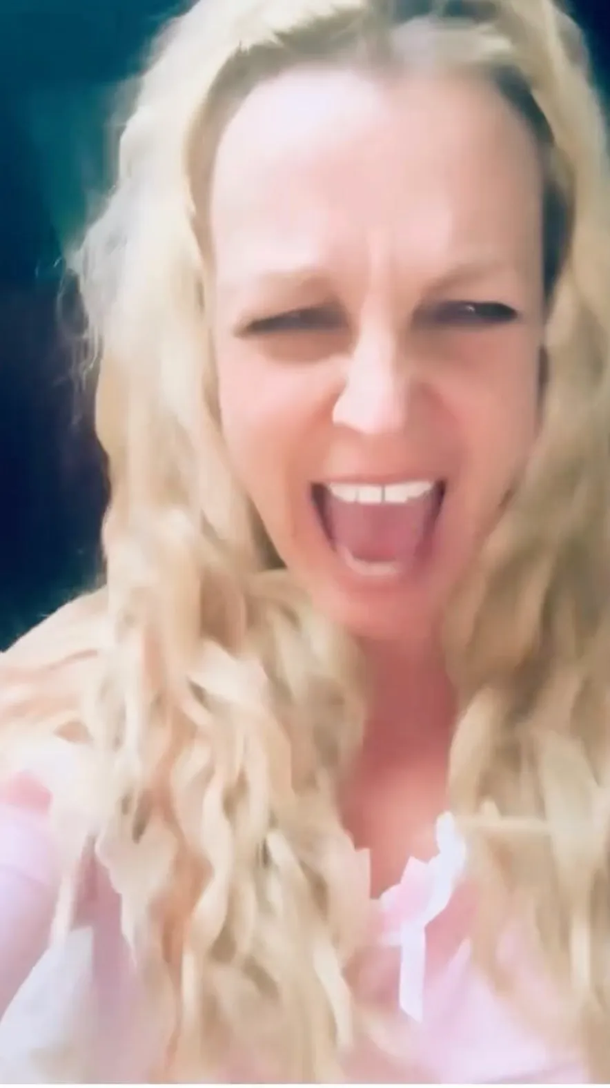 Britney Spears with a wide open mouth and closed eyes, expressing anger.