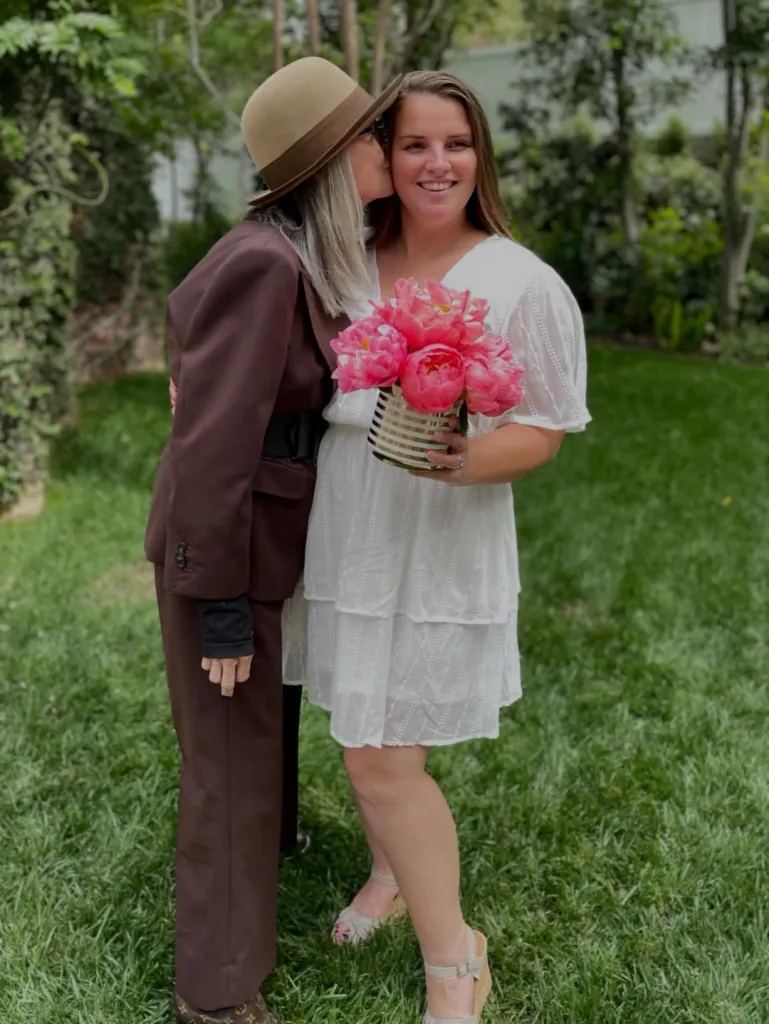 Diane Keaton's daughter, Dexie White, is kissed on the cheek by Diane Keaton.