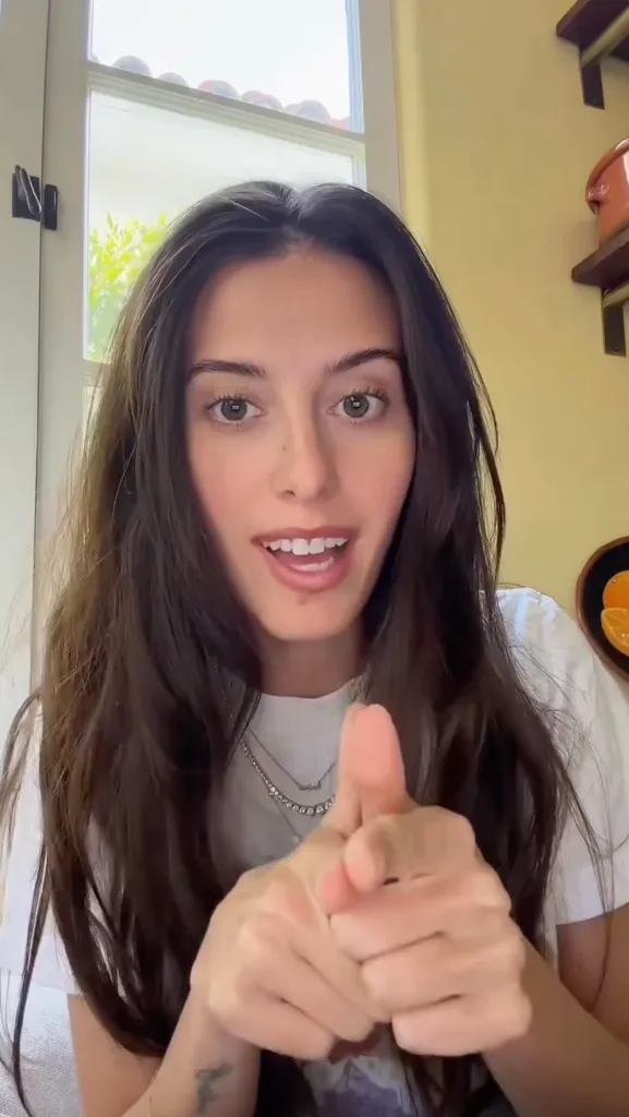 Lexi Manzo pointing her fingers at the camera.