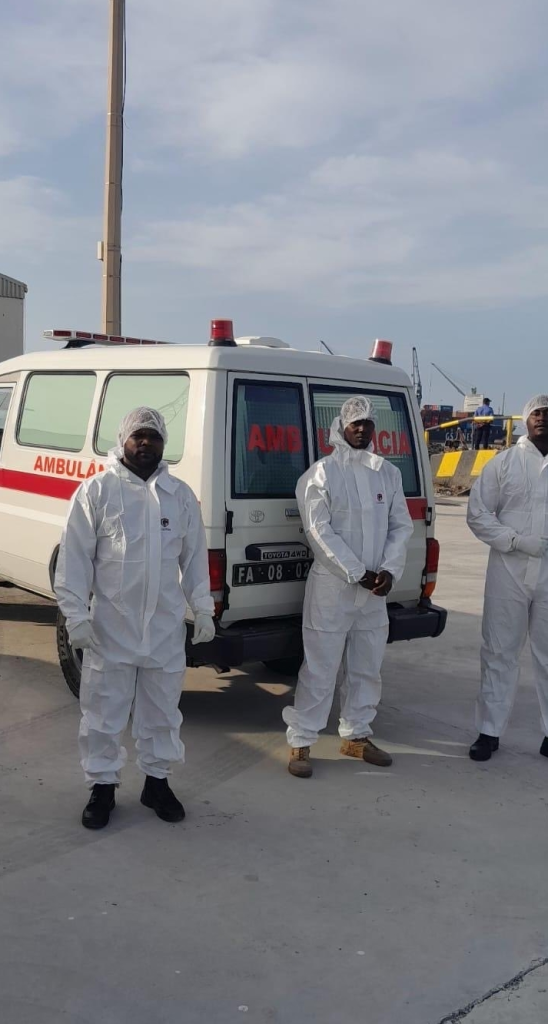 medical workers clad in hazmat suits near an ambulance