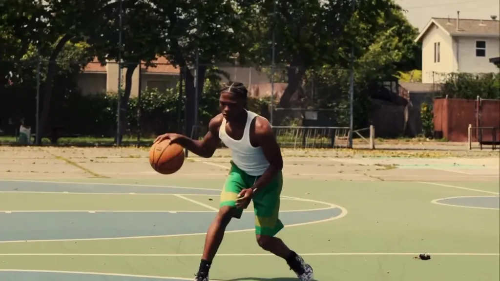Dominic Antoine Jr. dribbling a basketball on an outdoor court.