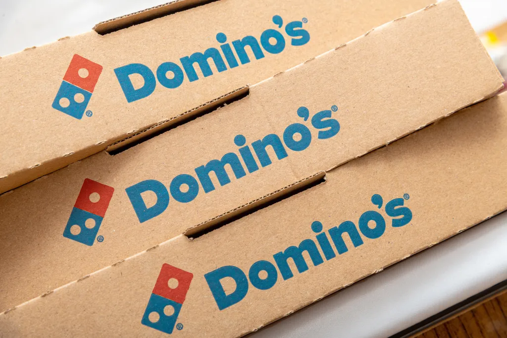 Domino's Pizza logos on three cardboard pizza boxes.