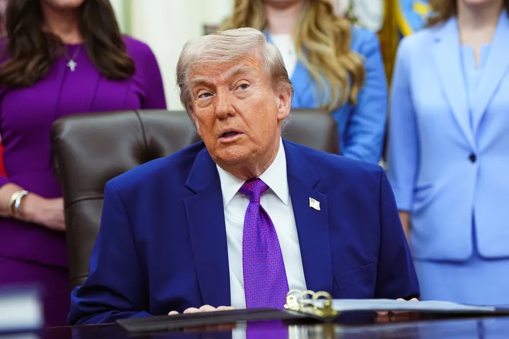 Donald Trump seated at a desk delivering remarks on maternal healthcare in the Oval Office.