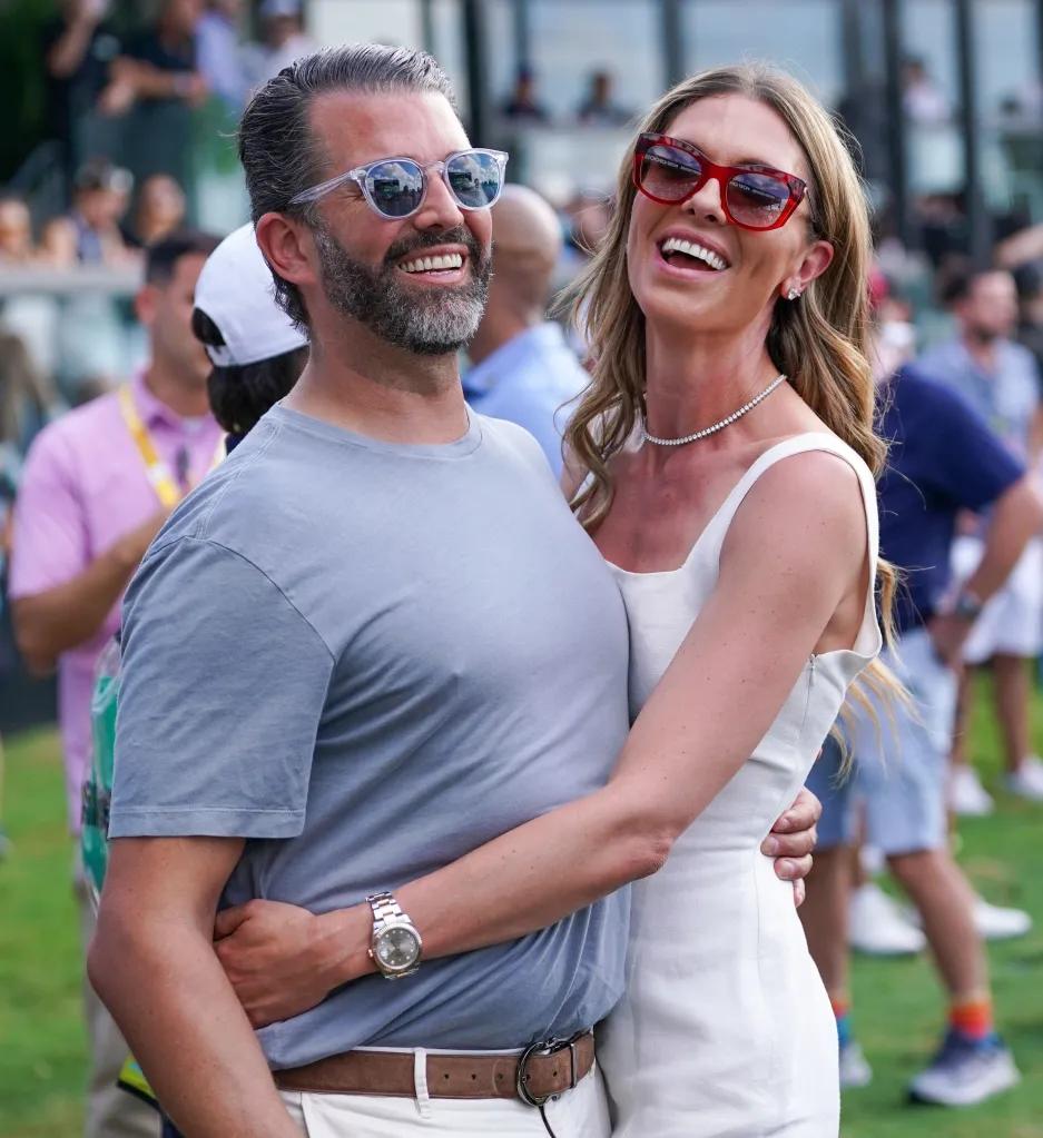 Donald Trump Jr. and Bettina Anderson laughing and embracing on the 18th green after the LIV Golf Miami final round.