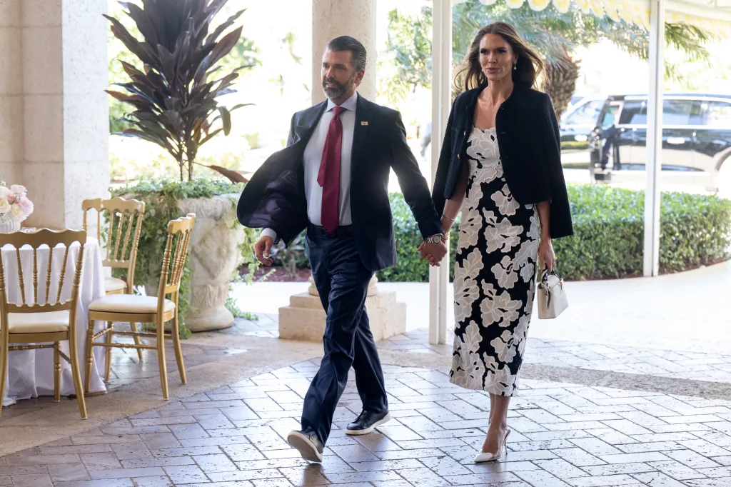 Donald Trump Jr. and Bettina Anderson, holding hands, attending a wedding at Mar-a-Lago in Palm Beach, Florida.