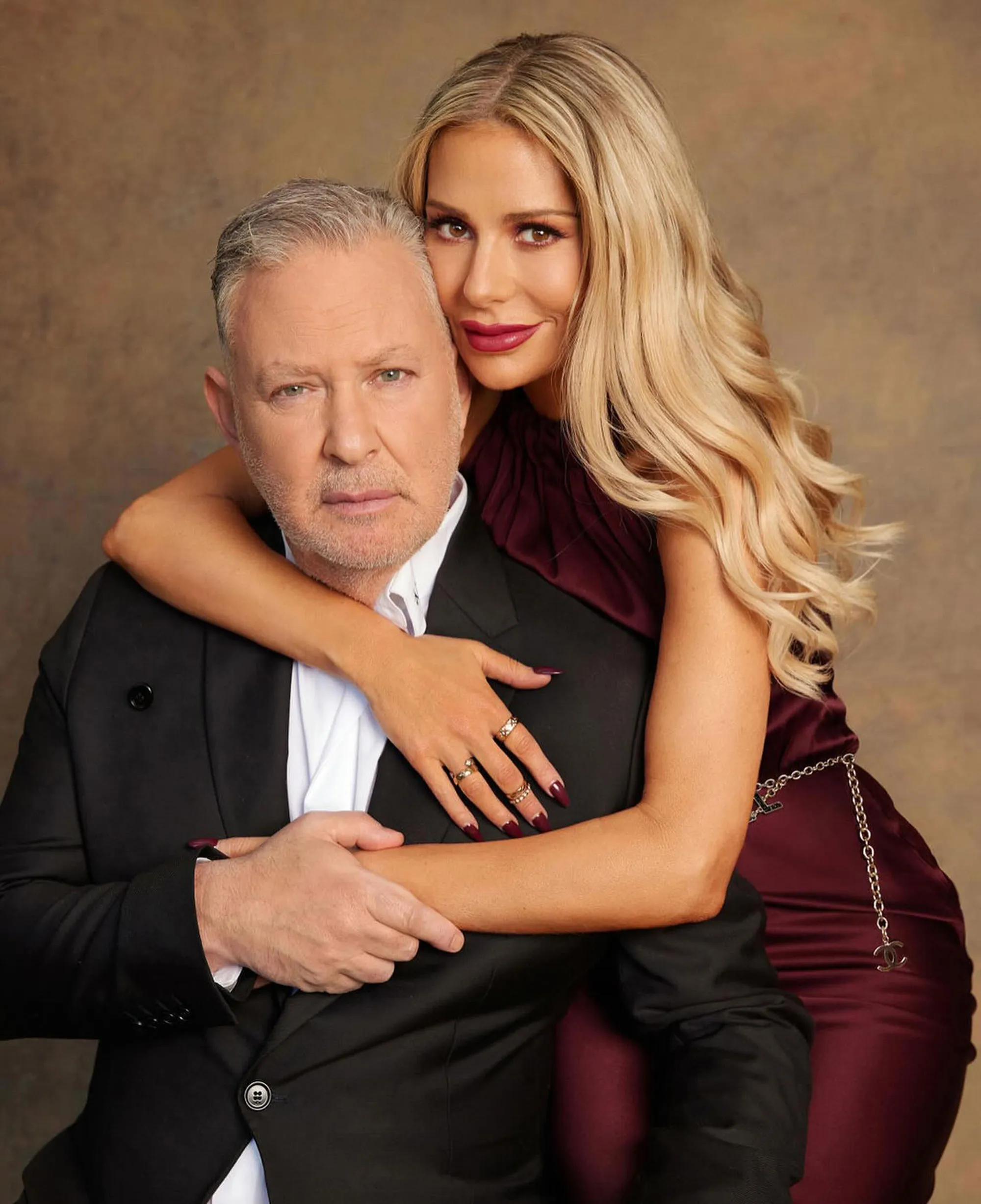 Dorit Kemsley embraces her husband PK in a formal portrait.