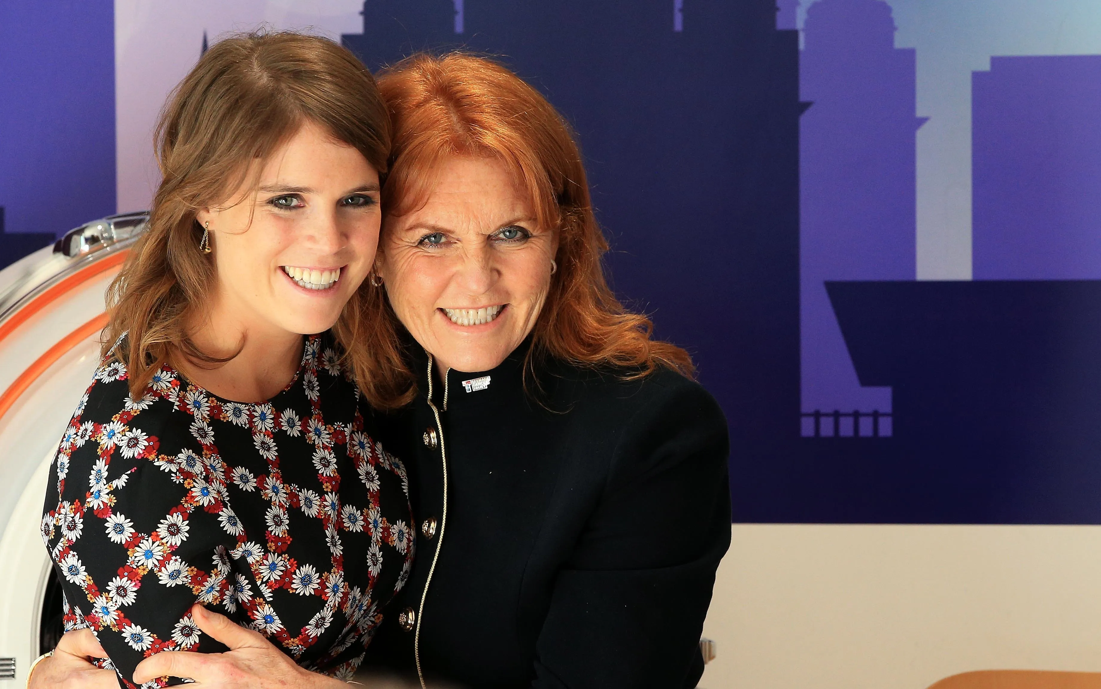 Duchess of York Sarah Ferguson and Princess Eugenie smiling at Alder Hey Hospital.