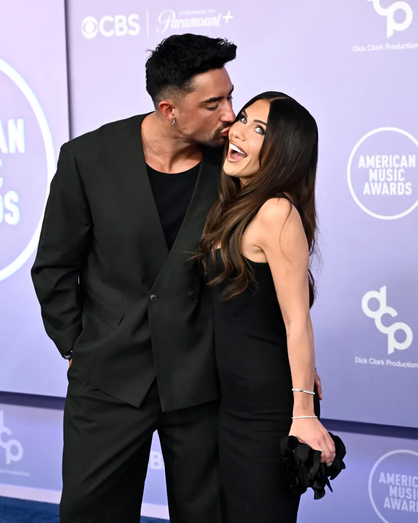 Marciano Brunette kisses Jessi Draper on the cheek at the 52nd American Music Awards.