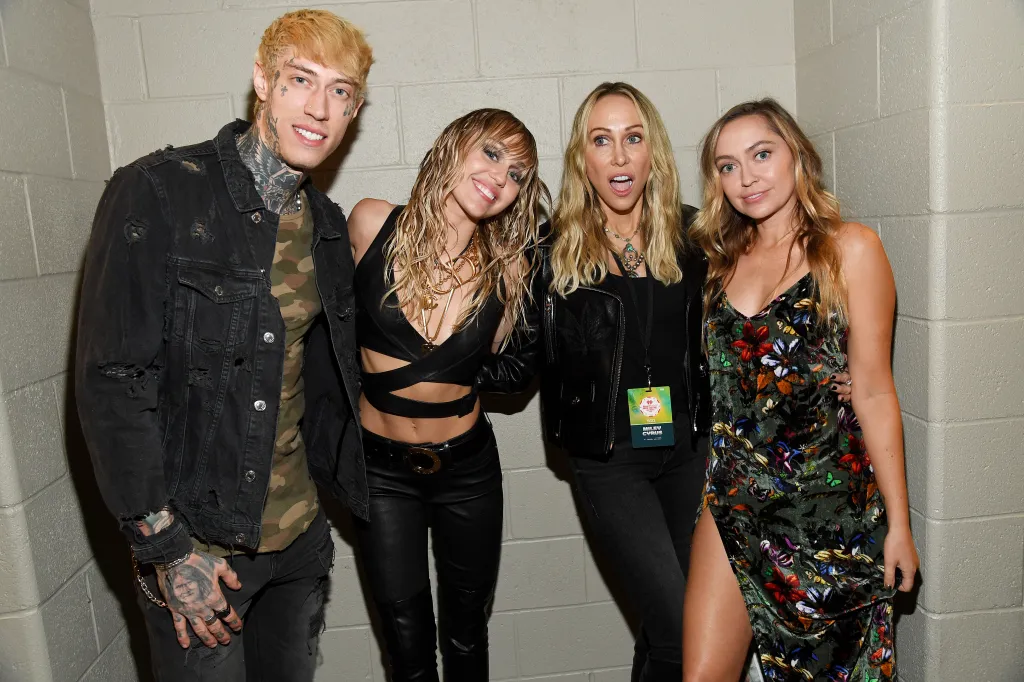 Trace Cyrus, Miley Cyrus, Tish Cyrus, and Brandi Cyrus pose backstage.