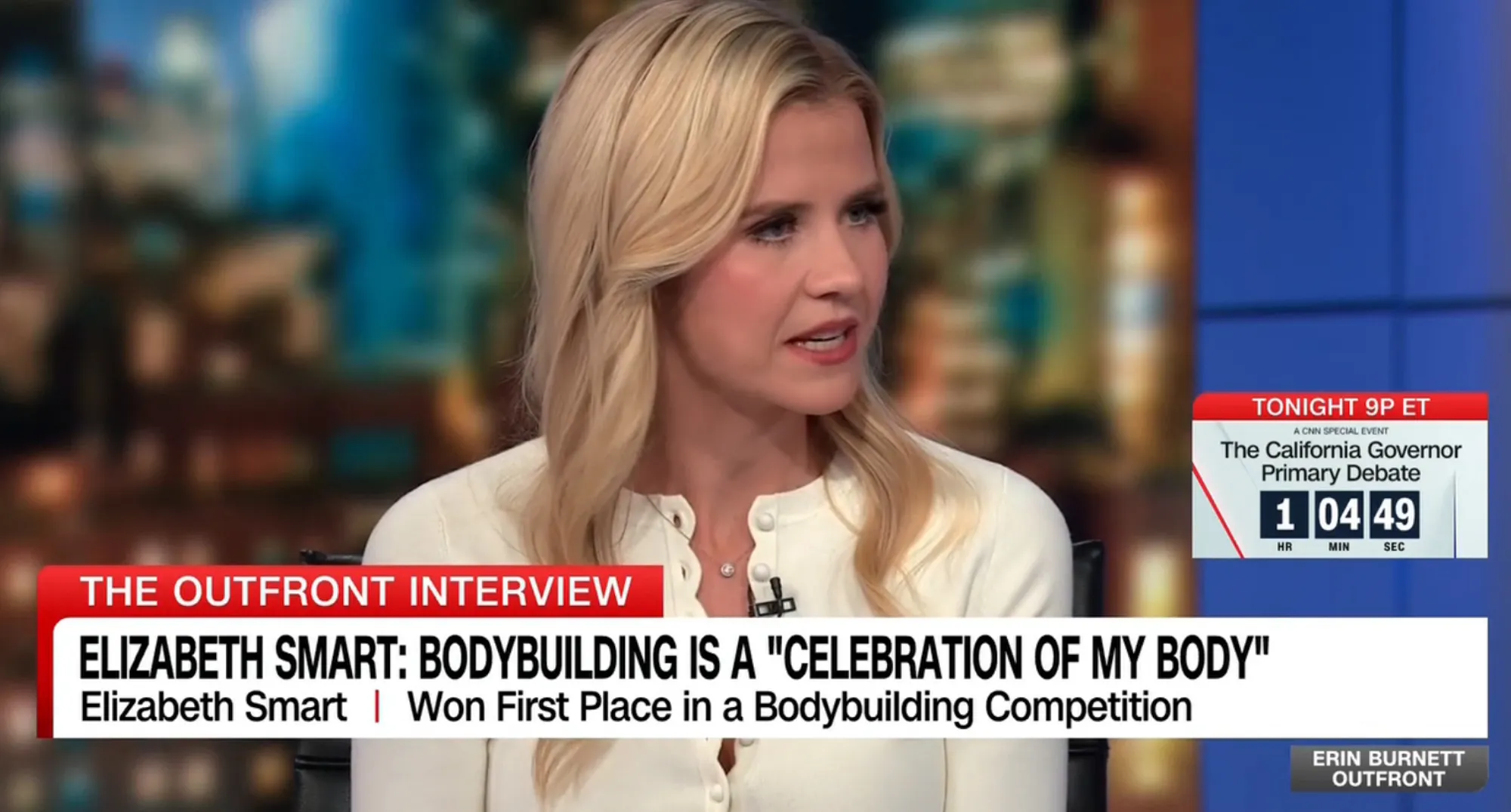 Elizabeth Smart interviewed on CNN's Erin Burnett Outfront, with text overlay discussing her winning a bodybuilding competition.