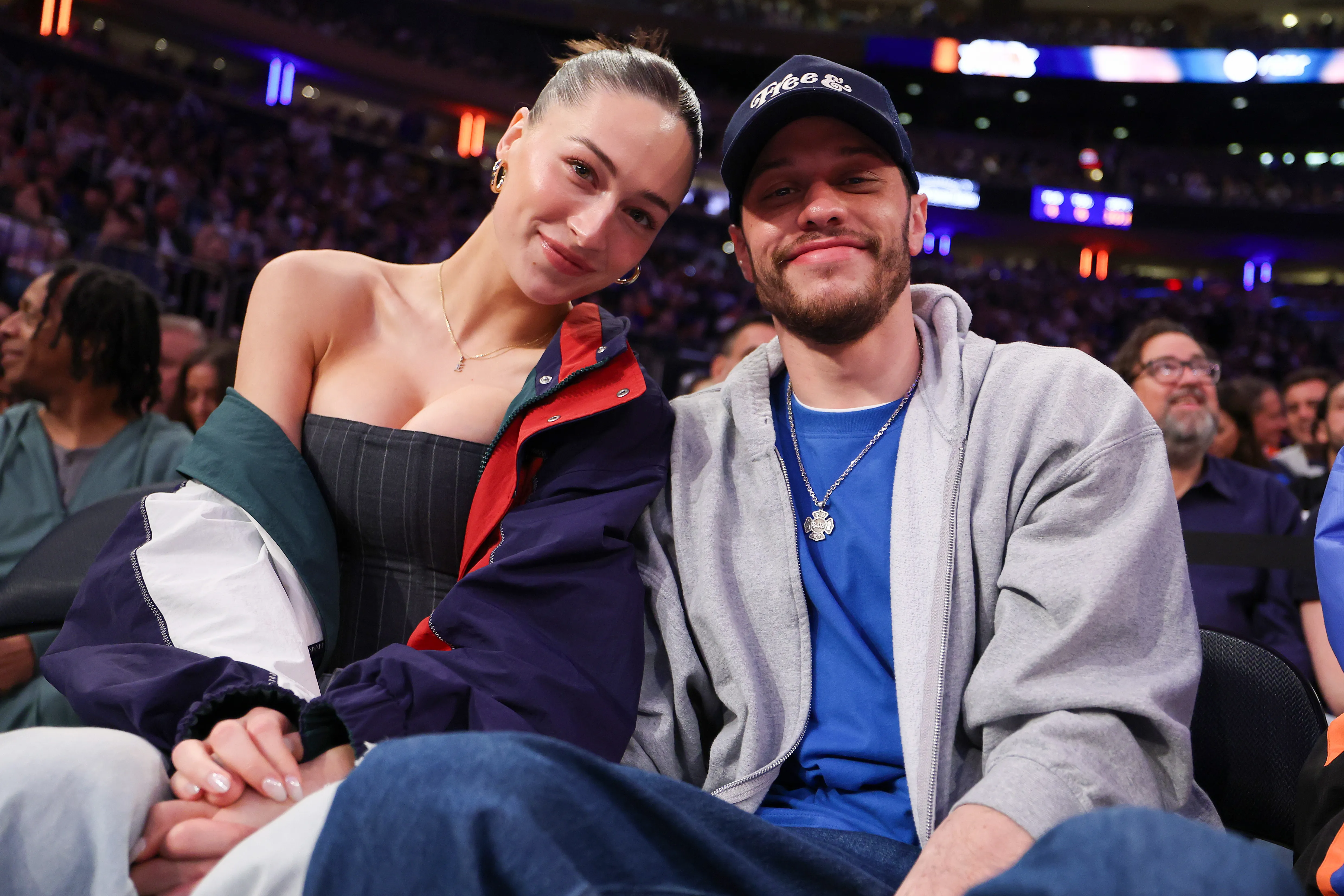 Elsie Hewitt and Pete Davidson seated at a basketball game