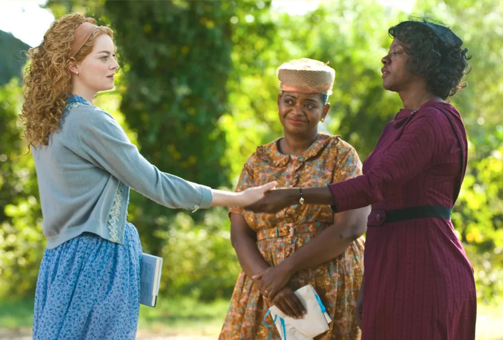 Emma Stone, Octavia Spencer, and Viola Davis shaking hands in 